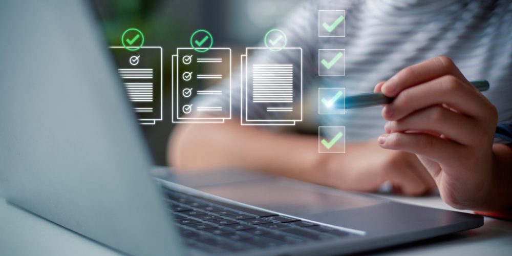 Person using stylus near laptop with floating digital checklists and green checkmarks