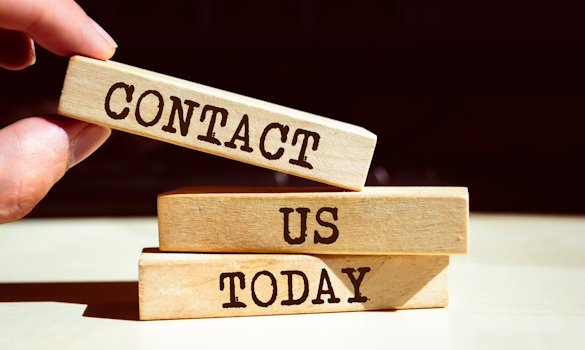 Text sign showing CONTACT US TODAY Wooden blocks stacked to read "Contact Us Today"