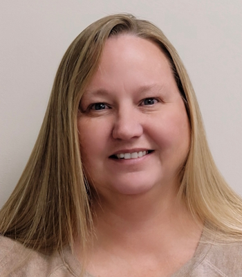 Portrait of a female Phil Patterson, Inc. employee smiling in front of a neutral background.