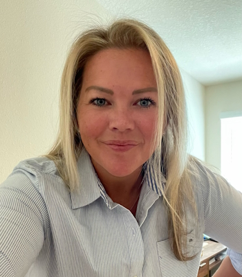 Portrait of a female Phil Patterson, Inc. employee in a striped shirt, smiling in a well-lit room.